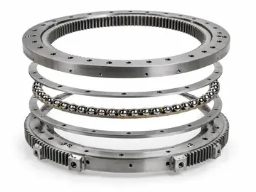 Exploded slewing bearing assembly with rings and rolling elements on white background