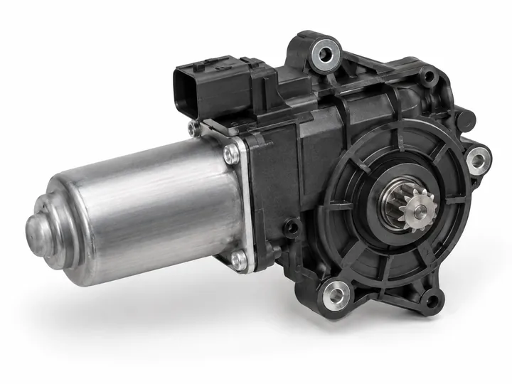 Black and silver power window regulator motor and gearbox assembly with drive gear on white background